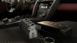 Automotive Accessories 4 Cylinder Engine Keychain Grey And Gold In The Interior Of A Red Sports Car