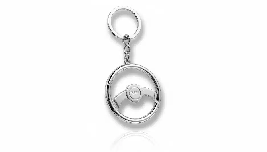 A stylish steering wheel keychain designed in a silver colour.