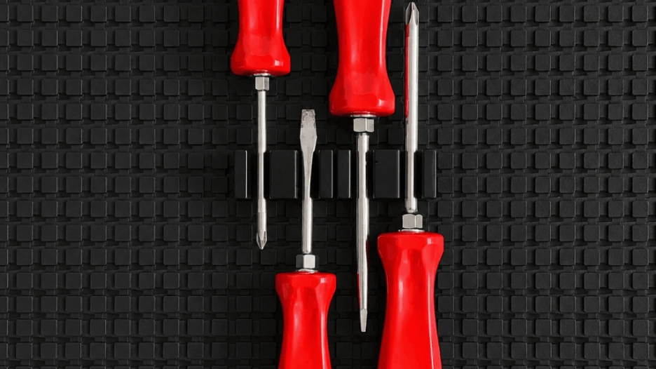 Magnetic screwdriver organizer securely holding red-handled screwdrivers on a non-slip toolbox drawer liner.